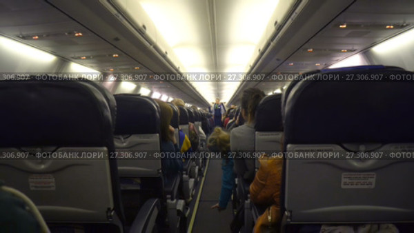 Moscow, Russian Federation – March 19, 2017: Interior of airplane with passengers on seats. Редакционное видео, видеограф Курганов Александр / Фотобанк Лори