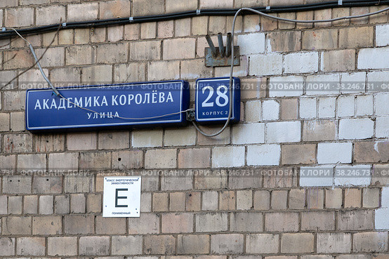 Москва, СВАО, микрорайон Марфино, улица Академика Королёва. Адресная табличка на доме 28 корпус 2 (серия II-28), включеном в программу реновации. Надпись на табличке "Класс энергетической эффективности Е пониженный" (2022 год). Стоковое фото, фотограф Наталья Николаева / Фотобанк Лори