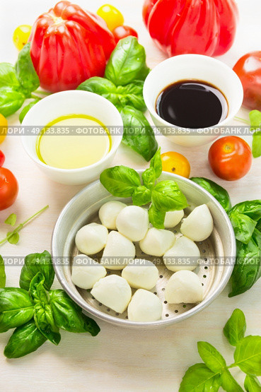 Mozzarella in bowl with basil leaves,oil,tomatoes and balsamic vinegar, italian food ingredients, close up. Стоковое фото, агентство Ingram Publishing / Фотобанк Лори