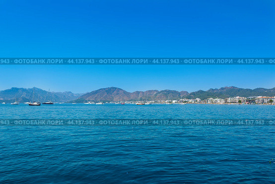 Mugla, Marmaris, Turkey - July 09, 2024: Island view on the Mediterranean coast of Turkey. Mediterranean beach during summer vacation. A warm holiday island in the Aegean Sea. Редакционное фото, фотограф Григорий Стоякин / Фотобанк Лори