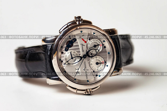 Munich, Swiss - 24 oct 2024: swiss wrist watch Ulysse Nardin SONATA Cathedral, close-up 3d. Silver wristband and bright steel dial, tachymeter, chronograph. Luxury watches concept. Copy ad text space. Редакционное фото, фотограф Aleksandr Golubev / Фотобанк Лори