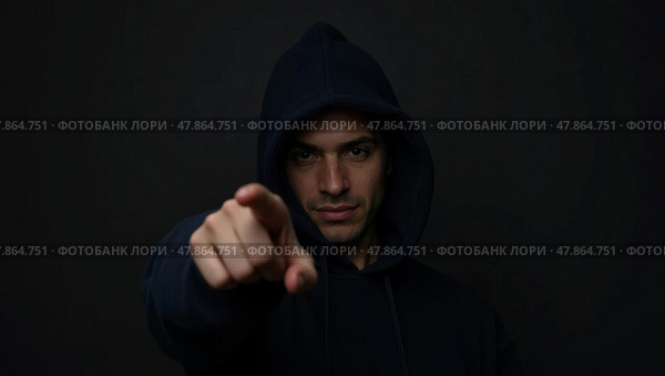 Mysterious lowkey portrait of a hooded individual with an emphatic gesture in dramatic lighting. Стоковое AI-изображение, AI-художник Андрей Бакусов / Фотобанк Лори