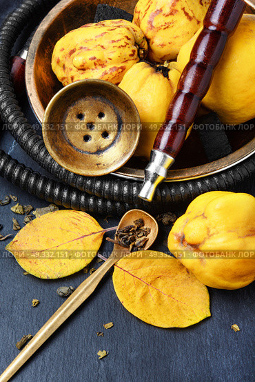 Nargile with quince. Smoking smoking hookah in Arabic style with the tobacco aroma of ripe quince. Стоковое фото, агентство Ingram Publishing / Фотобанк Лори