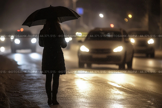 Night silhouette of woman with an umbrella on edge of busy road. Стоковое AI-изображение, AI-художник Владимир Григорьев / Фотобанк Лори