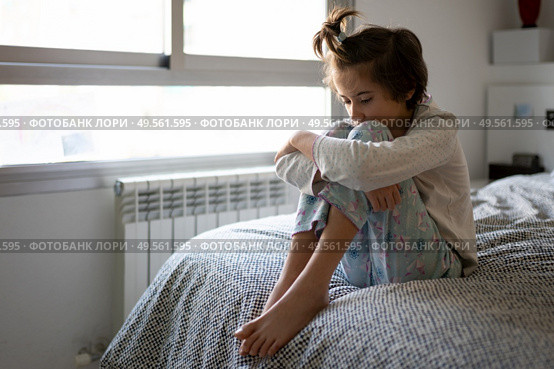 Nine-year-old girl sitting in bed at home bored by confinement. Nine-year-old girl sitting in bed bored by confinement. Стоковое фото, агентство Ingram Publishing / Фотобанк Лори