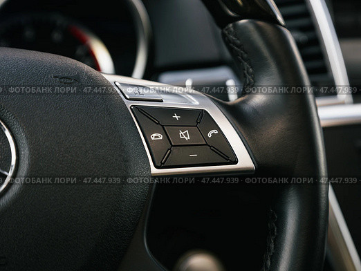 Novosibirsk, Russia -  March  23, 2024: Mercedes-Benz GL-class,  Close up of car steering wheel with function buttons. Стоковое фото, фотограф Виталий Сова / Фотобанк Лори