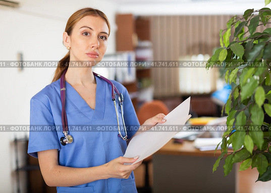 Nurse standing in hall with clipboard in hands. Стоковое фото, фотограф Яков Филимонов / Фотобанк Лори
