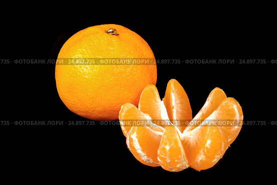 One fresh mandarin and one a peeled on a black background. Стоковое фото, фотограф Artem Sobov / Фотобанк Лори