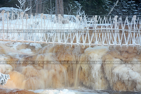 One of the most famous places in the Republic of Karelia is the Ruskeala waterfalls (the filming location of the Soviet film "The Dawns Here Are Quiet...") in the winter season. Traveling in Russia, Republic of Karelia. Стоковое фото, фотограф Алексей Кокоулин / Фотобанк Лори