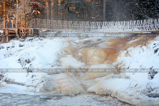 One of the most famous places in the Republic of Karelia is the Ruskeala waterfalls (the filming location of the Soviet film "The Dawns Here Are Quiet...") in the winter season. Traveling in Russia, Republic of Karelia. Стоковое фото, фотограф Алексей Кокоулин / Фотобанк Лори