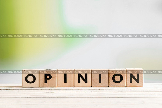 Opinion sign on a wooden indoor desk. Стоковое фото, агентство Ingram Publishing / Фотобанк Лори