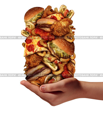 Over eating and compulsive indulgence of fast food concept as a hand holding up a huge stack of junk food as hamburgers hotdogs and french fries as an unhealthy diet nd bad nutrition symbol isolated on a white background. Стоковое фото, агентство Ingram Publishing / Фотобанк Лори