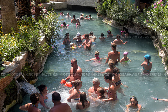 Pammukale, Turkey - July, 19, 2015: People in antique Cleopatra's pool with thermal water in ancient city Hierapolis, near modern Turkey city Denizli. Редакционное фото, фотограф Анна Кривицкая / Фотобанк Лори