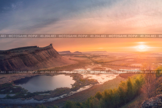 Panorama panoramic landscape nature mountains sunrise sunset of Chest butte or First Sunduk against blue sky. Sunduki mountain range from Devonian sandstone stone located in the valley of the Bely Iyus River in Khakassia, Russia. Стоковое фото, фотограф Владимир Разгуляев / Фотобанк Лори