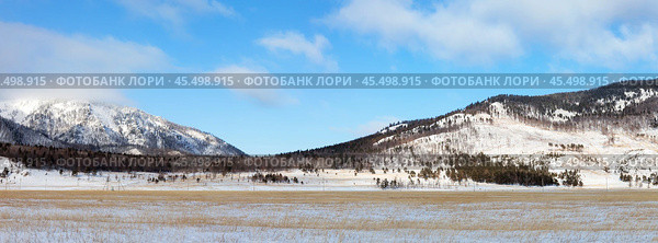 Panoramic view of Goloustnaya River valley framed by snow-capped mountains on sunny January day. Coast of Baikal Lake. Pribaikalsky National Park. Beautiful winter landscape. Natural background. Стоковое фото, фотограф Виктория Катьянова / Фотобанк Лори