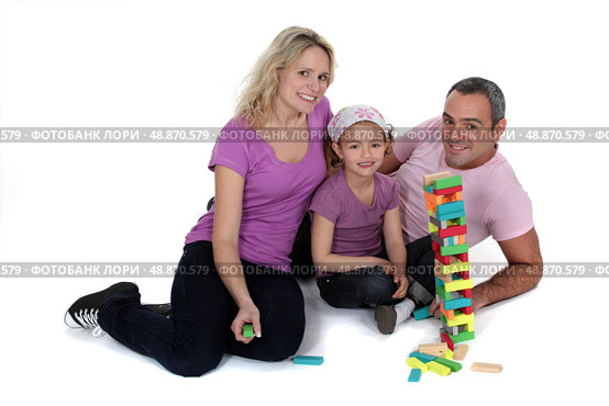 Parents playing with daughter on the floor. Стоковое фото, агентство Ingram Publishing / Фотобанк Лори