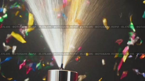 Party cannon launching confetti on black background. Стоковое видео, видеограф Данил Руденко / Фотобанк Лори