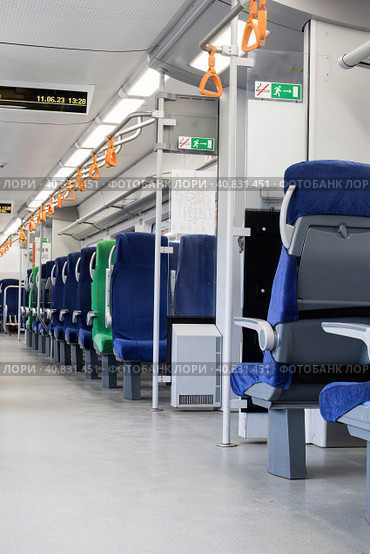 Passenger seats in an empty train. Rows of unoccupied seats. Стоковое фото, фотограф Константин Григорьев / Фотобанк Лори
