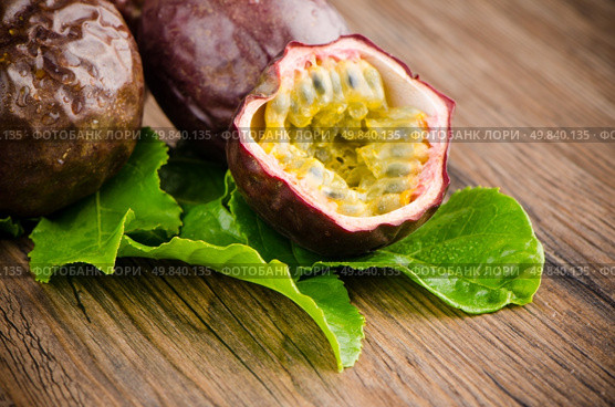Passion fruits on wooden background. Стоковое фото, агентство Ingram Publishing / Фотобанк Лори