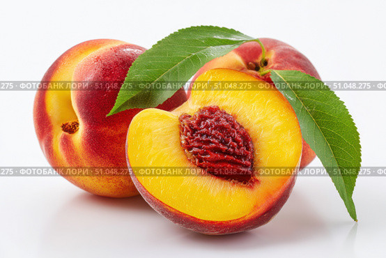 Peach isolate. Fresh Peach slice. Peach with leaf. Full depth of field. Clipping path. Slices of ripe peaches. Composition of peaches, peach halves and slices with green leaves on a white background. Стоковое AI-изображение, AI-художник Марина Демидюк / Фотобанк Лори