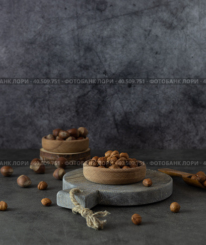 Peeled hazelnuts in a wooden bowl on a round stand. Стоковое фото, фотограф Анна Никитина / Фотобанк Лори