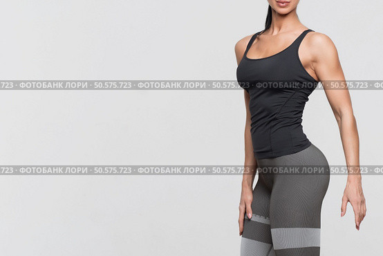 Perfect body young woman on a white background in sexy lingerie. Slim tanned woman body over gray background. Стоковое фото, агентство Ingram Publishing / Фотобанк Лори