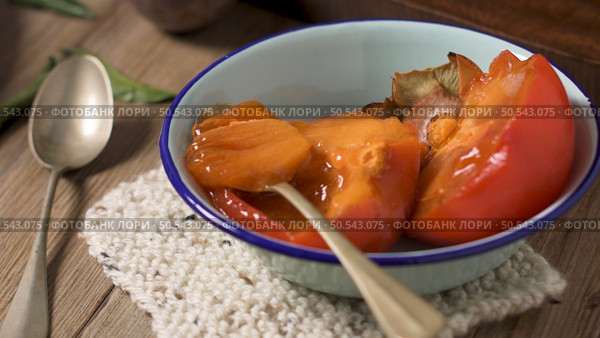 Persimmon fruit on rustic table in vintage style. Стоковое фото, агентство Ingram Publishing / Фотобанк Лори