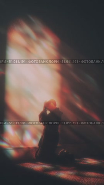 Person in silhouette in a dimly lit room contemplating inner thoughts with colorful light reflections. Стоковое AI-видео, аниматор Сергей Толмачёв / Фотобанк Лори