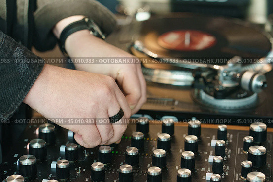 Photography of the modern premium stage mixed board / desk with vinyl turntable and vinyl plate. Close frontal view. Стоковое фото, фотограф YuryKara / Фотобанк Лори