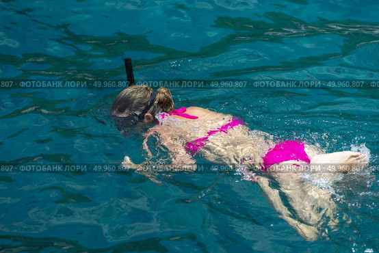 Phuket, THAILAND - JANUARY 4, 2017. A tourist wearing a bikini swim in the sea in Phuket. Редакционное фото, агентство Ingram Publishing / Фотобанк Лори