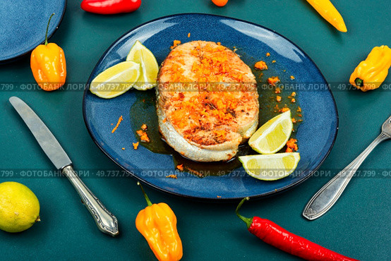 Plate of grilled trout steak with orange sauce. Healthy food with omega.. Grilled salmon steak in orange marinade. Стоковое фото, агентство Ingram Publishing / Фотобанк Лори