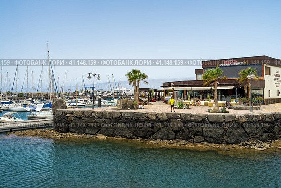 PLAYA BLANCA, LANZAROTE - JULY 18, 2022: Marina Rubicon of Playa Blanca. Playa Blanca is the southernmost town of the Spanish island of Lanzarote. It is the newest resort on the island. Редакционное фото, фотограф Sergey Kohl / Фотобанк Лори
