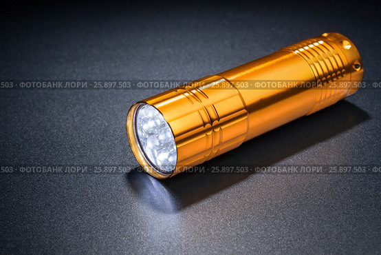 Pocket LED light on a dark surface. Стоковое фото, фотограф Alexander / Фотобанк Лори