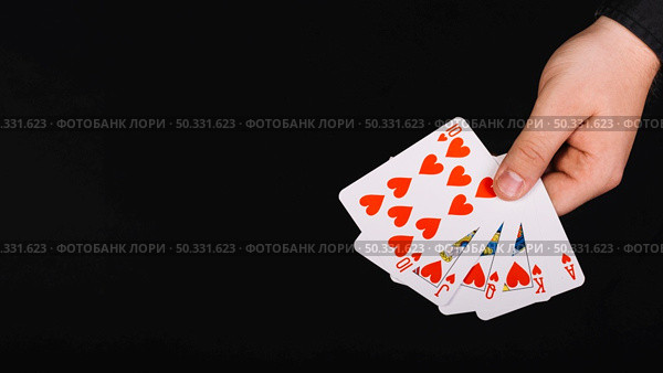 poker player s hand royal flush heart black background. High resolution photo. poker player s hand royal flush heart black background. High quality photo. Стоковое фото, агентство Ingram Publishing / Фотобанк Лори
