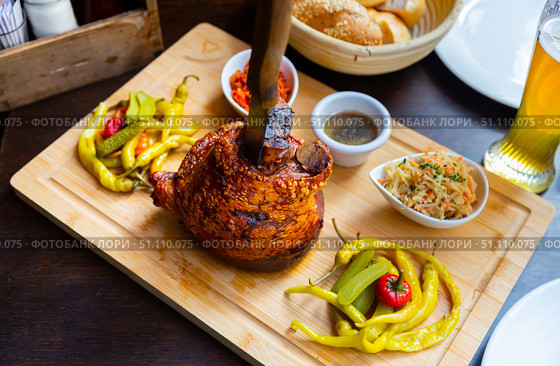 Popular dish of Austrian cuisine is roasted pork knuckle in beer sauce. Стоковое фото, фотограф Яков Филимонов / Фотобанк Лори