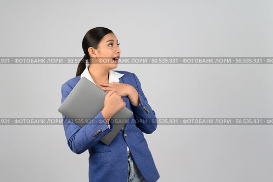 Portrait Asian young woman in officer uniform feel exciting during holding laptop computer in hand posture,  Pretty girl smiling with happy, isolated on white background. Стоковое фото, агентство Ingram Publishing / Фотобанк Лори