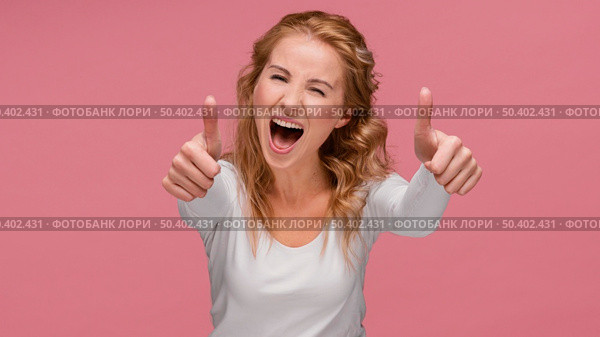 portrait female laughs shows ok sign. Стоковое фото, агентство Ingram Publishing / Фотобанк Лори