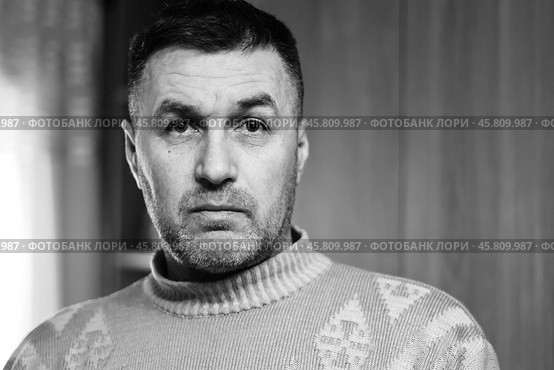 Portrait of a thoughtful and surprised middle-aged man in a wool sweater close-up black and white photo. Стоковое фото, фотограф Андрей С / Фотобанк Лори