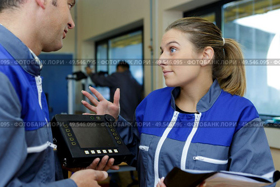 portrait of female operative talking to colleague. Стоковое фото, агентство Ingram Publishing / Фотобанк Лори
