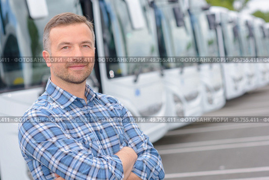 Portrait of man with fleet of buses. Стоковое фото, агентство Ingram Publishing / Фотобанк Лори