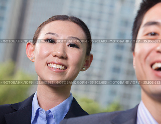 Portrait of two young business people outside in the business district, Beijing. Стоковое фото, агентство Ingram Publishing / Фотобанк Лори