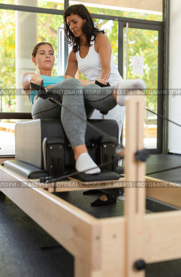 Positive activ hispanic female trainer controlling sports woman. Стоковое фото, фотограф Яков Филимонов / Фотобанк Лори