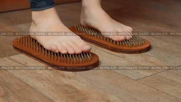 Practice of standing on nails, concept of feelings breakthrough. Стоковое фото, фотограф David Kashakhi / Фотобанк Лори