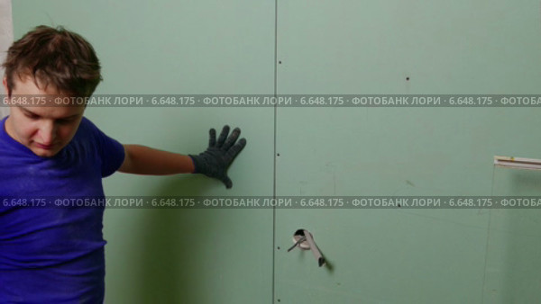 Рабочий закрепляет гипсокартон с помощью шуруповёрта. Стоковое видео, видеограф Discovod / Фотобанк Лори