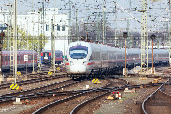 Railway station with modern high speed train in motion in the evening in Nuremberg, Germany. White train on the railroad track. Стоковое фото, агентство Ingram Publishing / Фотобанк Лори