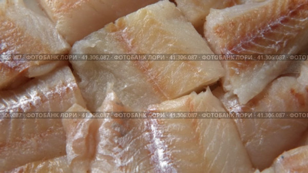 Raw fish fillet is spinning. Top view. Slices of fresh whitefish. Full frame. Sashimi rotation. Close up. Marine market. Video for sale. Cod, pollock loin steaks. Pangasius, tilapia pieces background. Стоковое видео, видеограф Марина Демидюк / Фотобанк Лори