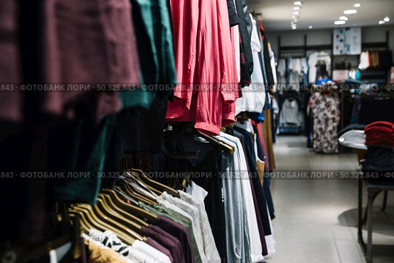 rows hangers with clothes. Resolution and high quality beautiful photo. rows hangers with clothes. High quality beautiful photo concept. Стоковое фото, агентство Ingram Publishing / Фотобанк Лори