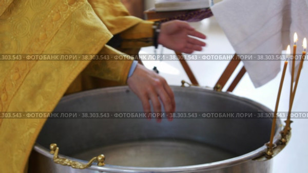 RUSSIA, KAZAN 08-28-2022: priest prepares font for baptism rite in church. Редакционное видео, видеограф Константин Шишкин / Фотобанк Лори