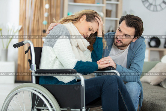 sad young woman in invalid chair and her boyfriend. Стоковое фото, агентство Ingram Publishing / Фотобанк Лори