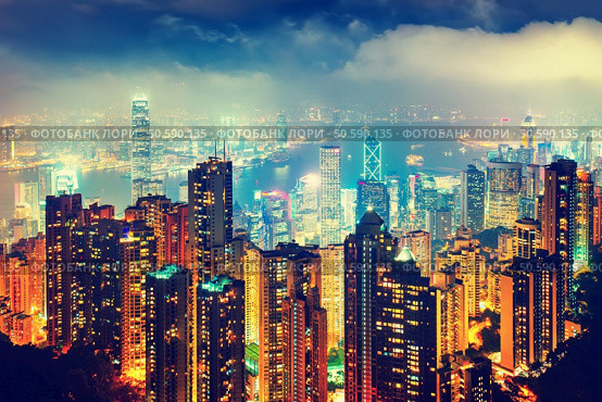 Scenic view over Hong Kong, China, by night. Nighttime skyline with illuminated skyscrapers seen from Victoria Peak. Стоковое фото, агентство Ingram Publishing / Фотобанк Лори